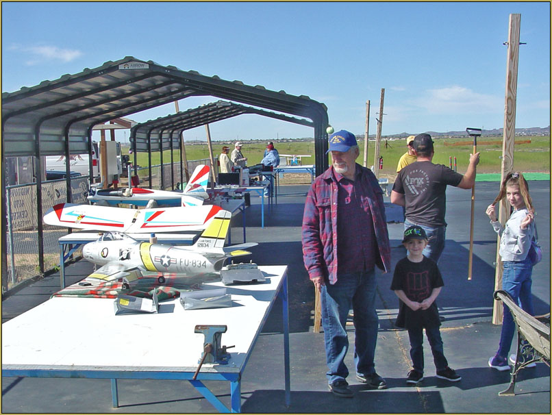 Beautiful day for flyin'! .Jack Carter Sr. and his grand-kids check out Eric's pile of models.