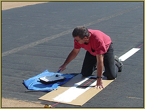 David Duke works on painting the stripe down the middle of our model runway!