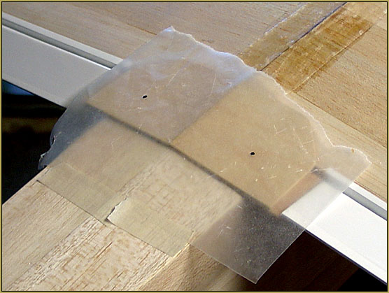 I mounted a flap of was-paper and marked the drill-locations on the blocks... then slid the wing into place.