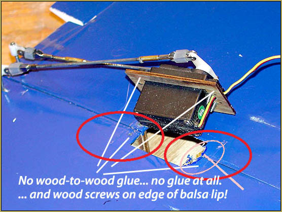 No glue and only a couple of wood screws through the edge of the balsa lip.